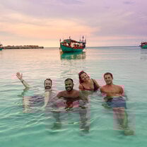 students swimming in the ocean at sunrise in Koh Rong