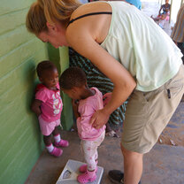 volunteer playing with two little girls