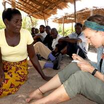 A volunteer doing Needs Assessment with a local