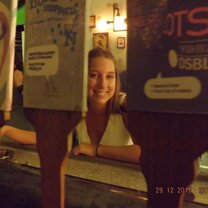 girl smiling at a bar