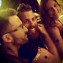 two men and a woman smiling 
