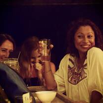 woman at bar holding drink