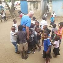 Dave surrounded by children from the refugee camp