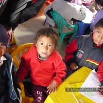 young girl sitting with a volunteer