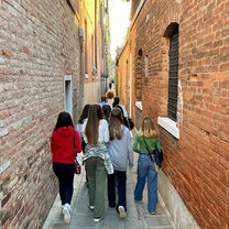 students walking through a street in Venice