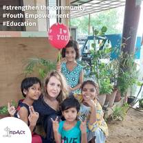 female volunteer with four young kids 
