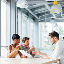 three students looking at papers together