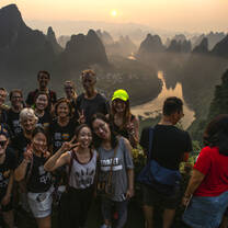 Students infront of a sunrise on Husband Moutain
