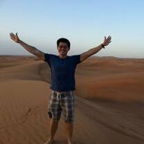 intern with arms spread out in desert