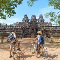 two people on bicycles in Angkor Wat