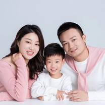 two parents smiling with a young boy