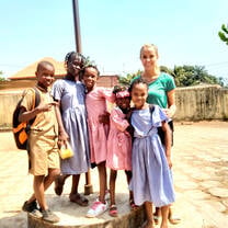 Teacher in Africa with 5 young girls