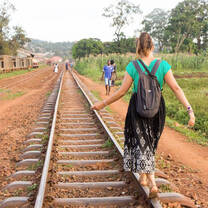 woman balancing on train tracks in sahara