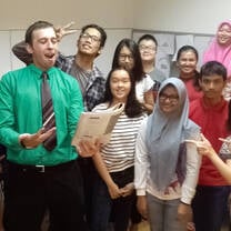 teacher reading a book to 8 students 