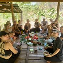 a group poses for a photo while eating dinner 