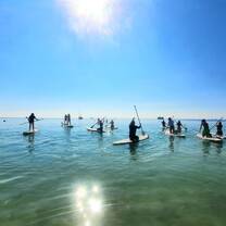 a group paddleboards on clear waters