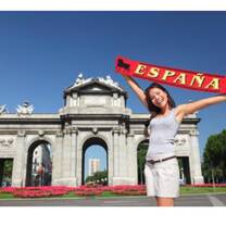Woman touting a España sash next to the Puerta de Alcala 