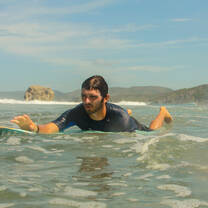 Boy Surfing in the clear waters in Costa Rica