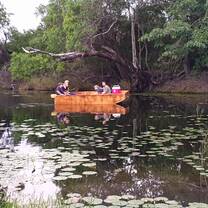 people in an orange boat conducting river research