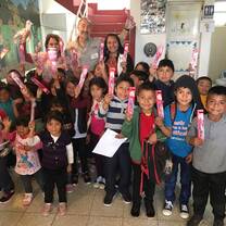 Group of young children against red stairs