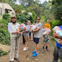Group of people outdoors holding bags
