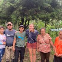 volunteer standing with her host family