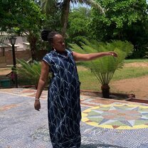 woman wearing traditional African dress doing a cultural dance