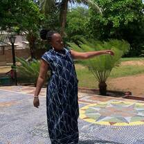 woman wearing traditional African dress doing a cultural dance