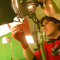 Boy changing a stage light