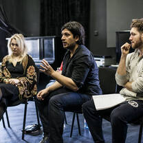 Three students sitting during a class critique 