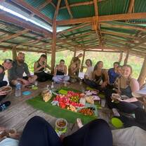 a group poses for a photo around a local meal 