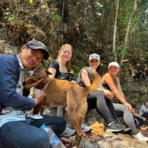 a group poses for a photo with a dog 