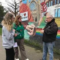 Students meet with a community speaker in Belfast