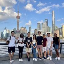Students posing with Shanghai skyline behind them 