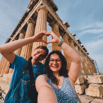 Two CYA students at the acropolis making a heart with their hands