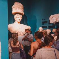 students in museum looking at sculpture