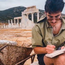 student at archaeology dig taking notes