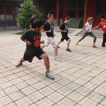 Students practicing kung fu in courtyard