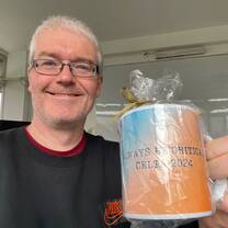 Tutor holding a cup given as a present
