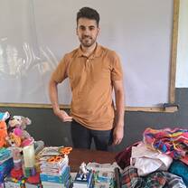 GXVO volunteer donating education materials to a local school