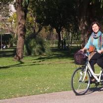 Student riding a bike in a Seville park