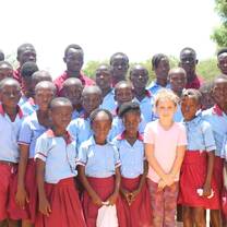 GXVO volunteer in a group picture with daughter and local students