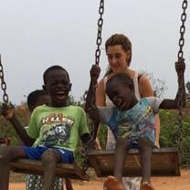A GXVO volunteer playing with children