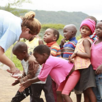 GXVO volunteer with local kids