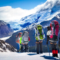 NOLS students crest the top of a mountain pass