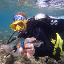 Student collecting garbage from ocean