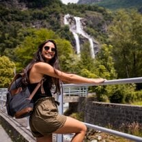 Woman smiling near waterfall
