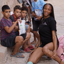 Student helping children