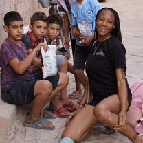 Student helping children
