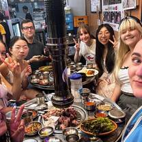 Women selfie enjoying a meal of Korean Barbecue